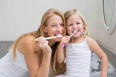 Mother and daughter brushing