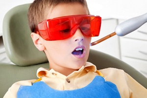 A young boy in the dentist chair