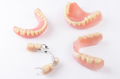 A series of full and partial dentures.