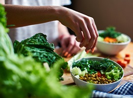 Hands with manicured nails making salads
