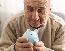 Man holding a blue piggy bank