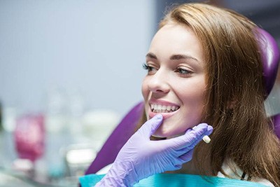 Dentist in Crown Point examining a patient’s mouth