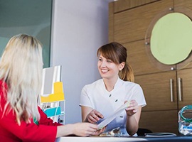 dental team member explaining pricing information to a patient 