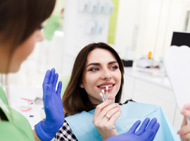 Patient looking at different shades of veneers