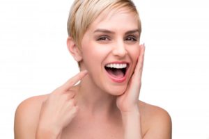 A woman smiling after her cosmetic dental consultation.