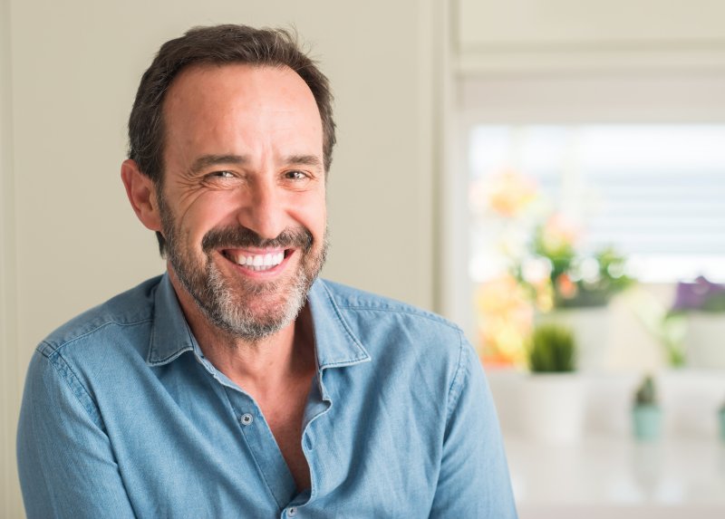 A man smiling after getting a dental filling