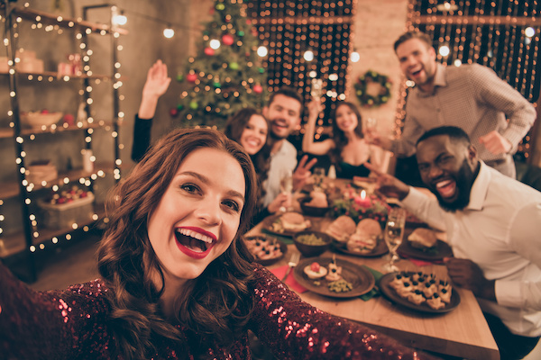 partygoers around table at holiday party