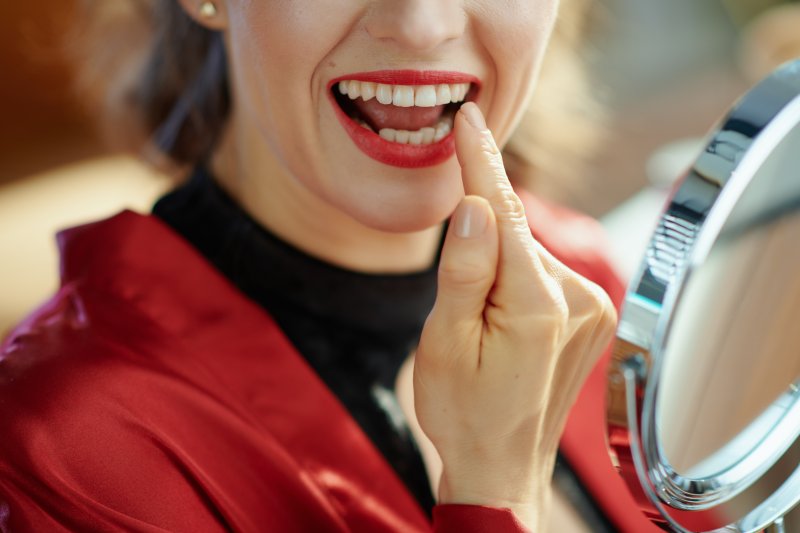 Lady inspects dental crown