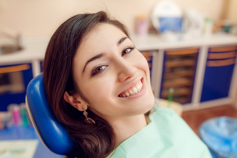 person smiling after being treated by cosmetic dentist
