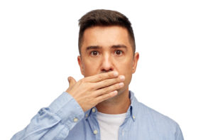 Man hiding his teeth.