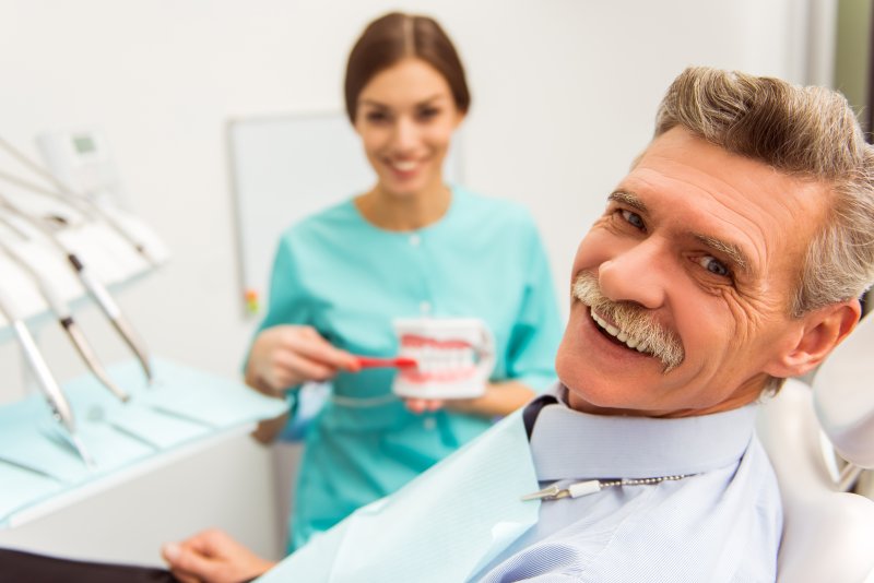 A patient getting dental checkups with dentures in Crown Point