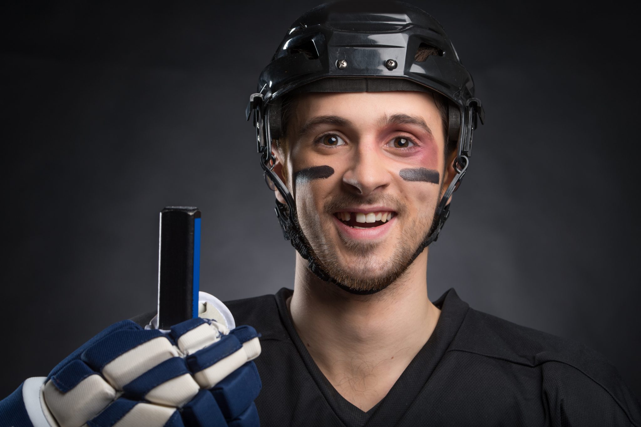 Funny hockey player smiling with one tooth missing. Berquist Family